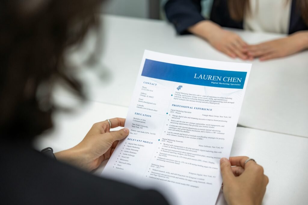 Hiring manager reviewing a resume with candidate contact details and address information