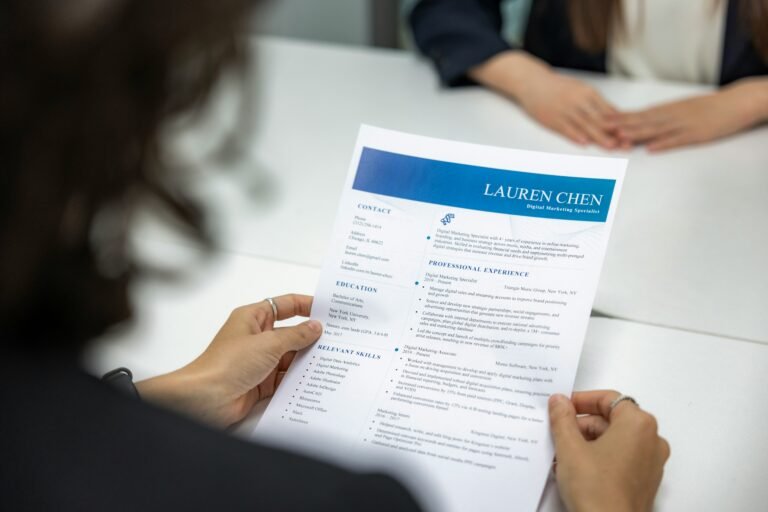 Hiring manager reviewing a resume with candidate contact details and address information