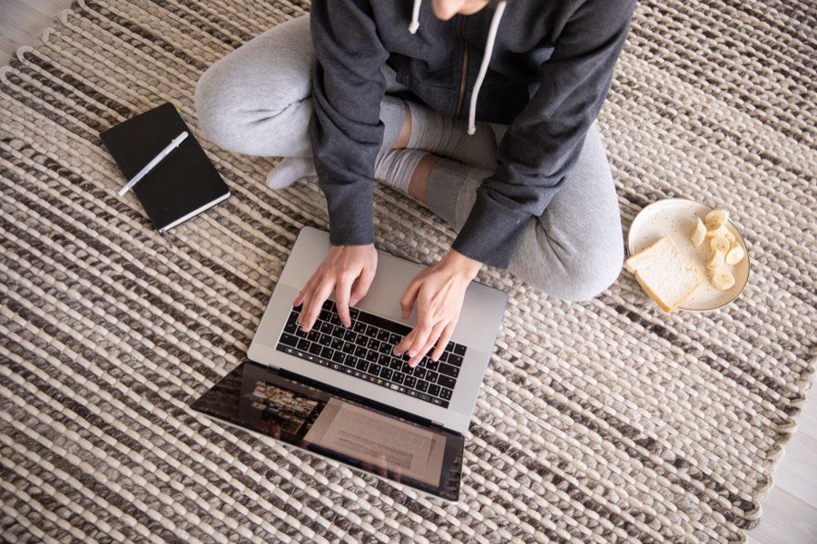 Person typing a move-out notice to their landlord on a laptop at home